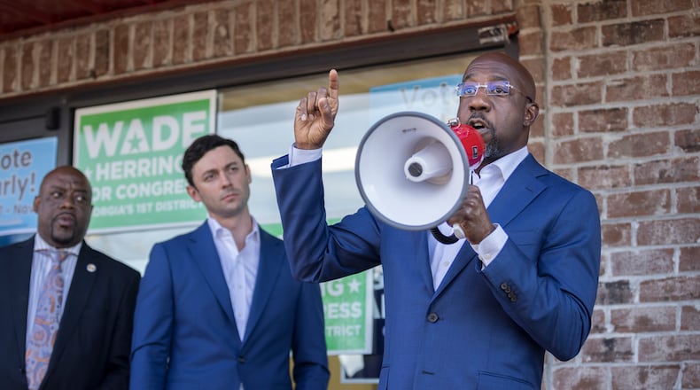 SAVANNAH, GA - OCTOBER 25, 2022: Georgia Democratic Senate candidate Raphael Warnock, right, Sen. Jon Ossoff (D-Ga), center, and Savannah Mayor Van Johnson, left, meet with supporters in front of a canvassing office Tuesday, Oct. 25, 2022, in Savannah, Ga. Ossify and Warnock spoke to supporters who where about to canvass neighborhoods in the area. (AJC Photo/Stephen B. Morton)