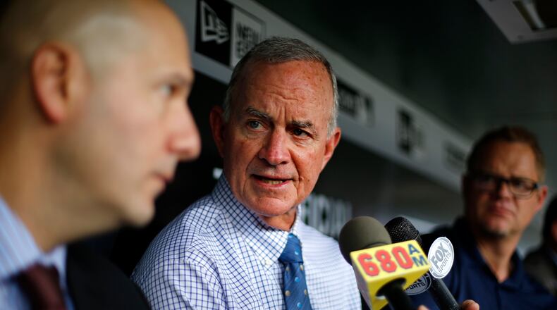 Atlanta Braves president of baseball operations John Hart, center, and general manager John Coppolella, left, meet with reporters in the dugout before a game against the Pittsburgh Pirates on Tuesday, May 17, 2016. The Braves fired manager Fredi Gonzalez earlier in the day. (AP Photo/Gene J. Puskar)