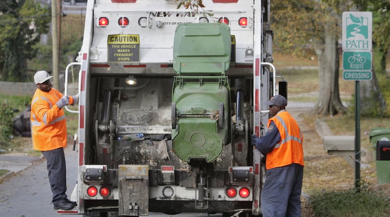 A city of Atlanta garbage crew collects trash in 2012. Bob Andres bandres@ajc.com