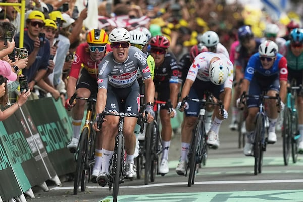 Belgium's Jasper Philipsen celebrates as he crosses the finish line to win the first stage of the Tour de France cycling race over 184.9 kilometers (114.9 miles) with start and finish in Lille, France, Saturday, July 5, 2025. (AP Photo/Thibault Camus)