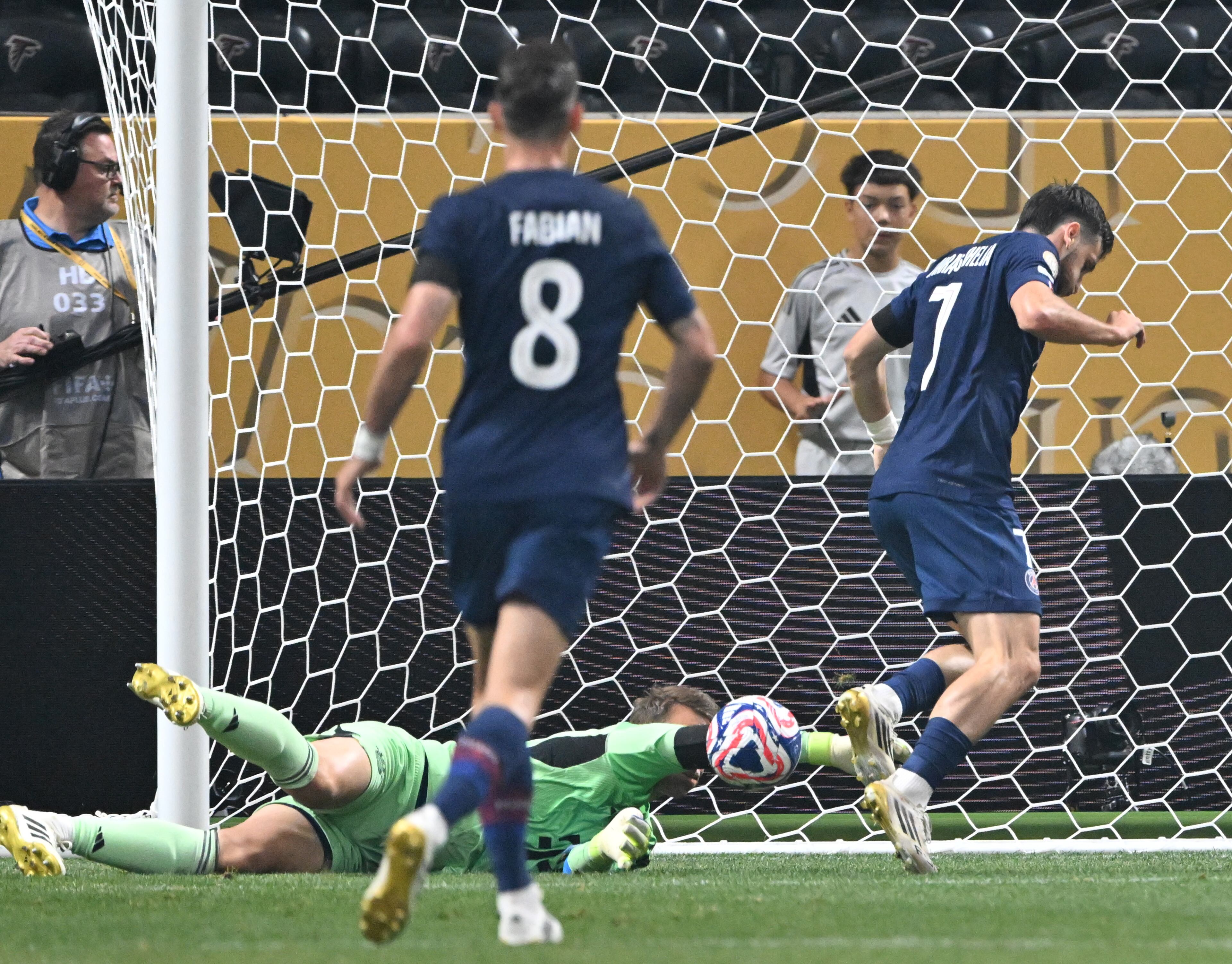 Bayern Munich goalkeeper Manuel Neuer (ground) blocks a shot by Paris Saint-Germain's Khvicha Kvaratskhelia (right) during the first half of the Club World Cup quarterfinals match at Mercedes-Benz Stadium on Saturday, July 5, 2025, in Atlanta. (Hyosub Shin/AJC)