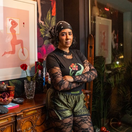 Cece Barrett in her Midtown condo living room where she started hosting meet-ups for friends and like-minded women decentering men and romance.  (Jenni Girtman for The Atlanta Journal-Constitution)