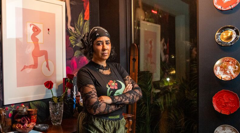 Cece Barrett in her Midtown condo living room where she started hosting meet-ups for friends and like-minded women decentering men and romance.  (Jenni Girtman for The Atlanta Journal-Constitution)