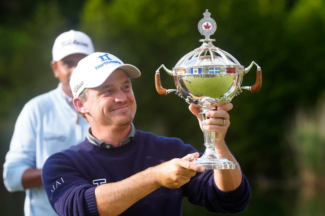 Bud Cauley, of the United States, holds the trophy after winning the Canadian Open golf tournament in Caledon, Ontario, Sunday June 14, 2026. (Frank Gunn/The Canadian Press via AP)