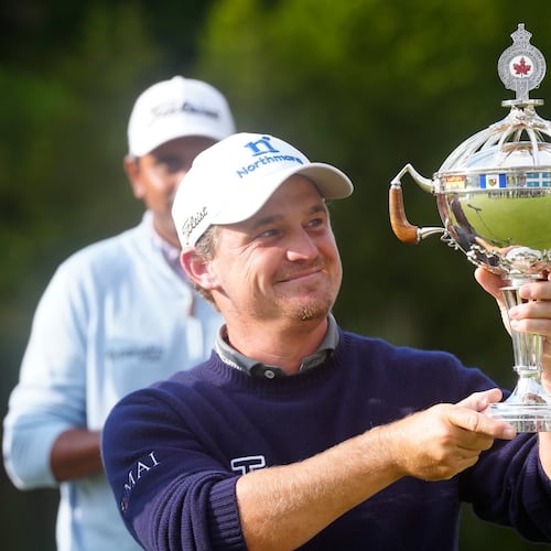 Bud Cauley, of the United States, holds the trophy after winning the Canadian Open golf tournament in Caledon, Ontario, Sunday June 14, 2026. (Frank Gunn/The Canadian Press via AP)