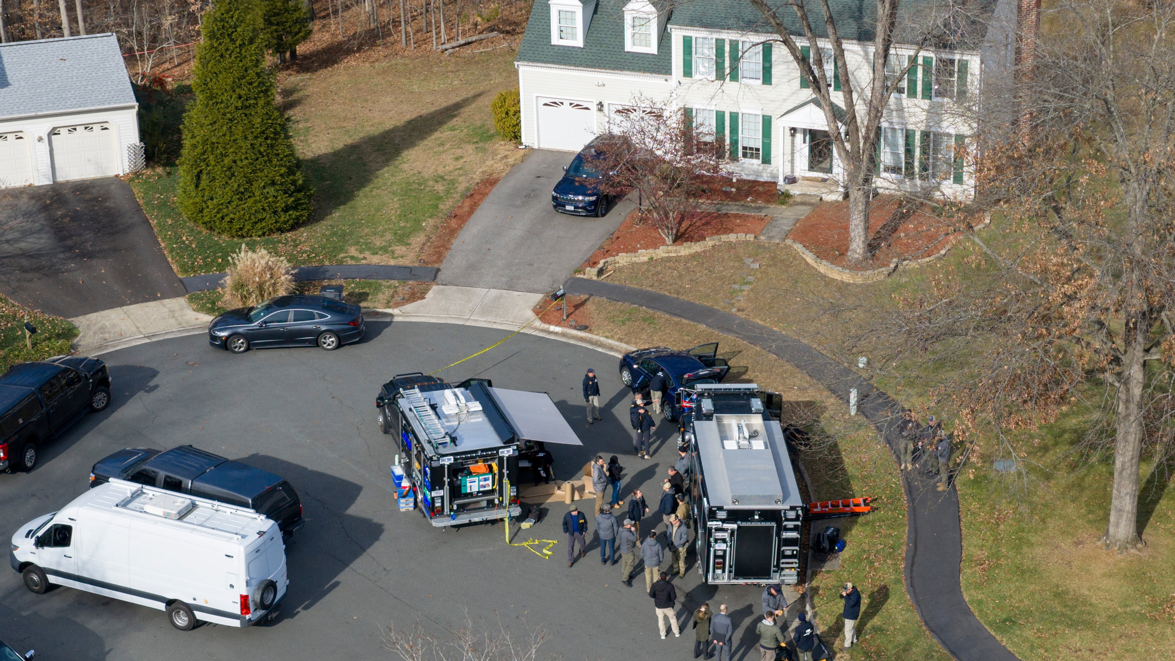 Prince William County Police block the street near the house where the FBI made an arrest, in Woodbridge, Va., Thursday, Dec. 4, 2025. (AP Photo/Steve Helber)