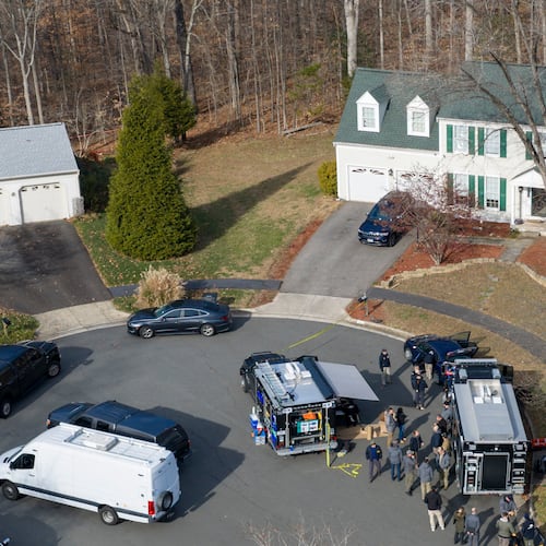 Prince William County Police block the street near the house where the FBI made an arrest, in Woodbridge, Va., Thursday, Dec. 4, 2025. (AP Photo/Steve Helber)