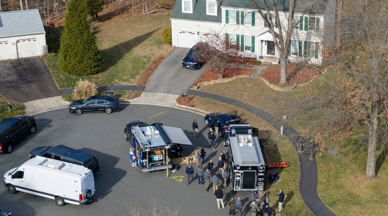 Prince William County Police block the street near the house where the FBI made an arrest, in Woodbridge, Va., Thursday, Dec. 4, 2025. (AP Photo/Steve Helber)