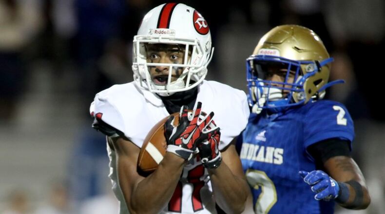 North Gwinnett wide receiver Josh Downs (11) catches a pass against McEachern defensive back Dacari Collins (2) in the first half during the Class 7A quarterfinals at McEachern High School Friday, November 29, 2019 in Powder Springs, Ga. (JASON GETZ/SPECIAL TO THE AJC)