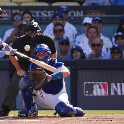 FILE - Philadelphia Phillies' Kyle Schwarber connects for a double during the first inning in Game 4 of baseball's National League Division Series against the Los Angeles Dodgers, Oct. 9, 2025, in Los Angeles. (AP Photo/Jae C. Hong, File)