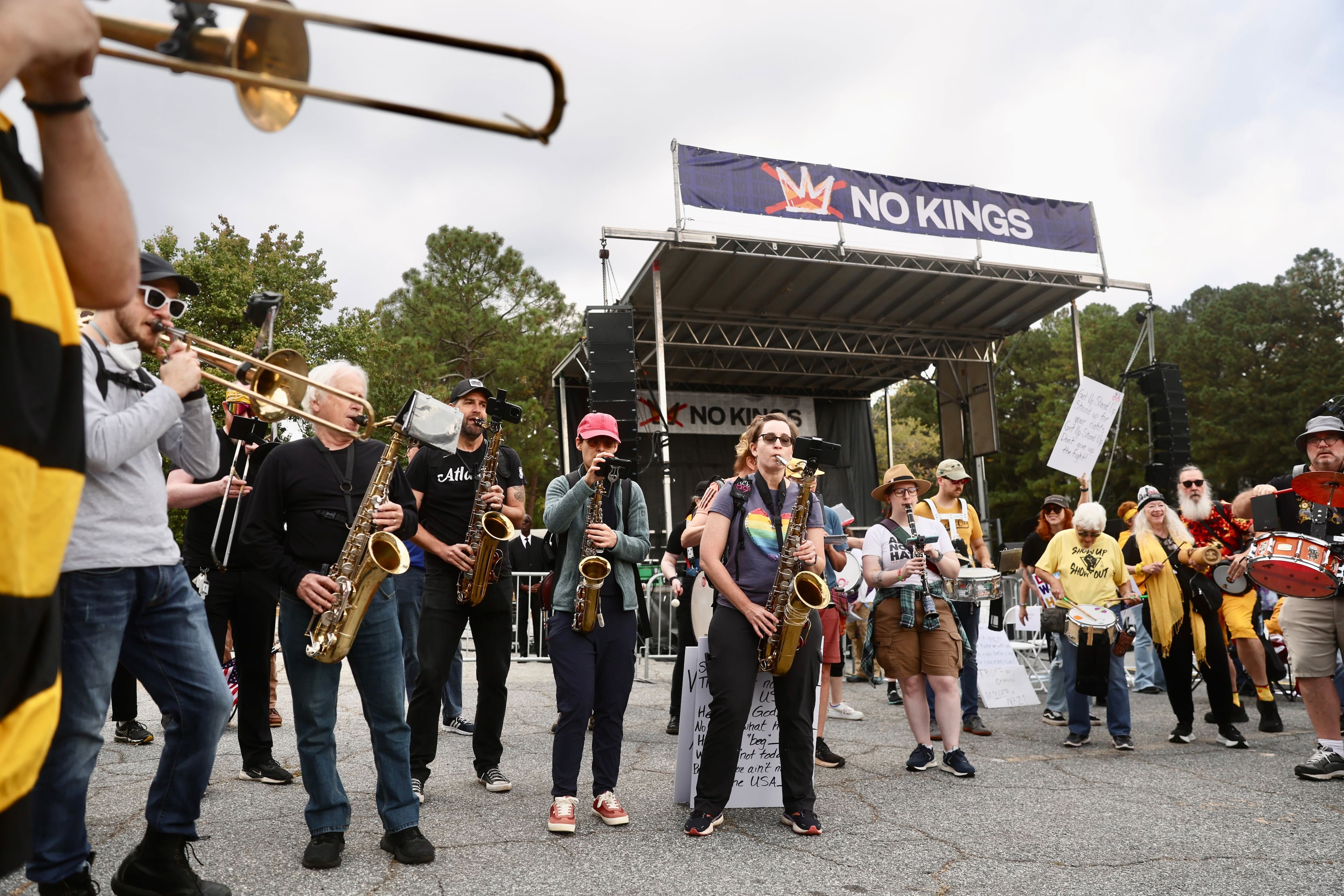 "No Kings" protests are taking place nationwide, with many of them being held in metro Atlanta. Saturday morning, hundreds of people convened at the Atlanta Civic Center. (Abbey Cutrer / AJC)