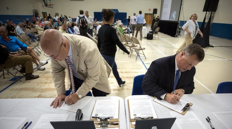 Two Glynn County residents fill out comment cards during a public hearing to discuss the Federal Aviation Administration’s recently released environmental impact study about the potential site for a spaceport in Kingsland. (Stephen B. Morton for The Atlanta Journal-Constitution)
