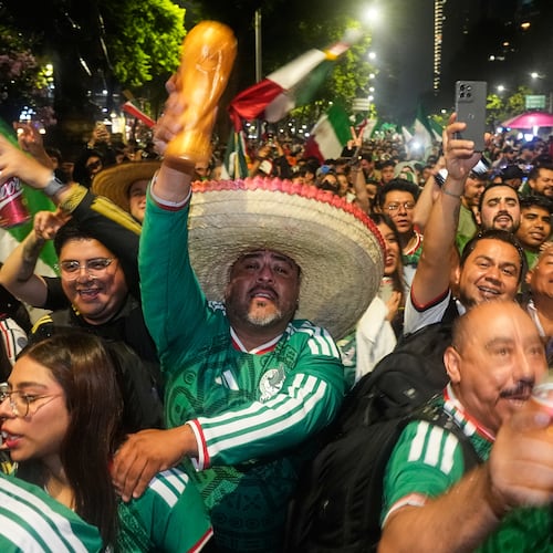 Mexican fans celebrate after beating South Korea during the World Cup Group A soccer match, at the Angel of Independence monument in Mexico City, Thursday, June 18, 2026. (AP Photo/Marco Ugarte)