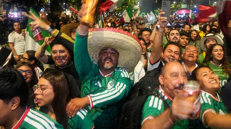 Mexican fans celebrate after beating South Korea during the World Cup Group A soccer match, at the Angel of Independence monument in Mexico City, Thursday, June 18, 2026. (AP Photo/Marco Ugarte)