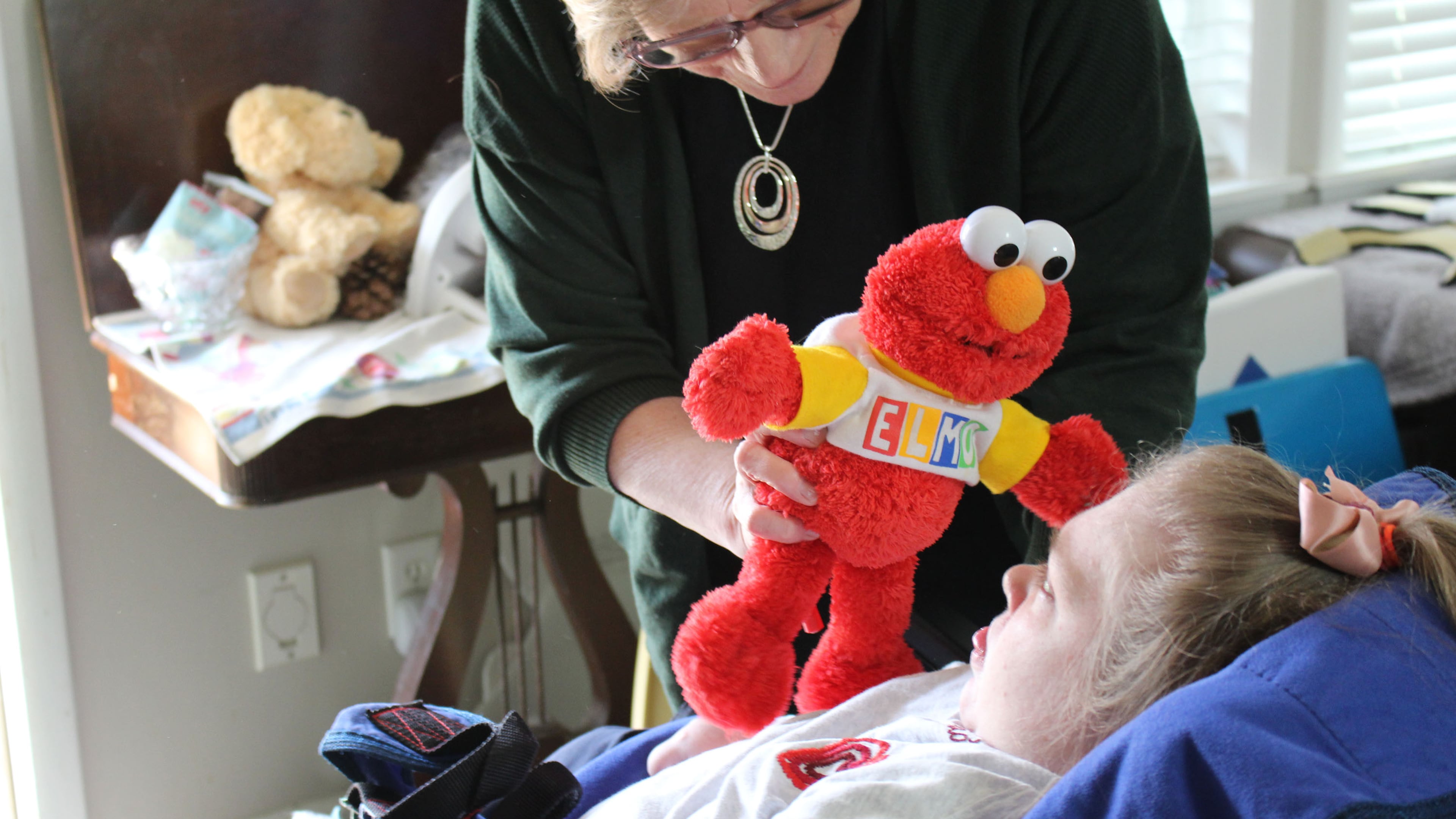 Sarah Smith needs round-the-clock care because of a rare genetic disorder called Dravet syndrome. Her mother, Sandra Smith, worries potential cuts to Medicaid funding could mean an end to the optional in-home care her Medicaid program covers. (Bram Sable-Smith/KFF Health News/TNS)