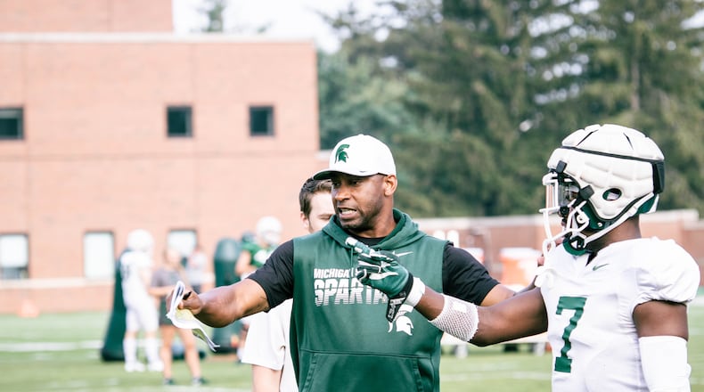 Michigan State assistant coach Travares Tillman works with a Spartans defensive back during practice. (Photo courtesy of Michigan State Athletics)