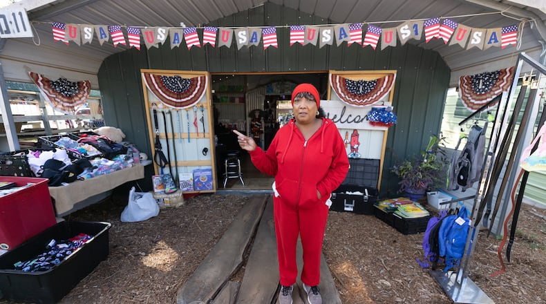 Felicia Flecha-Johnson talks about her merchandise at her booth at Sweeties Flea Market, located off U.S. 19/41, in Hampton. Steve Schaefer/steve.schaefer@ajc.com