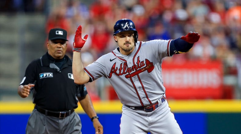 Atlanta Braves outfielder Adam Duvall is day to day after getting hit by a pitch on his left hand Saturday against the host Reds. (AP Photo/Aaron Doster)