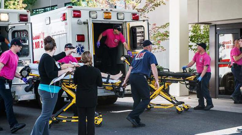 A patient is wheeled into the emergency room at Mercy Medical Center in Roseburg, Ore., following a deadly shooting at Umpqua Community College, in Roseburg, Thursday, Oct. 1, 2015. (Aaron Yost/Roseburg News-Review via AP)