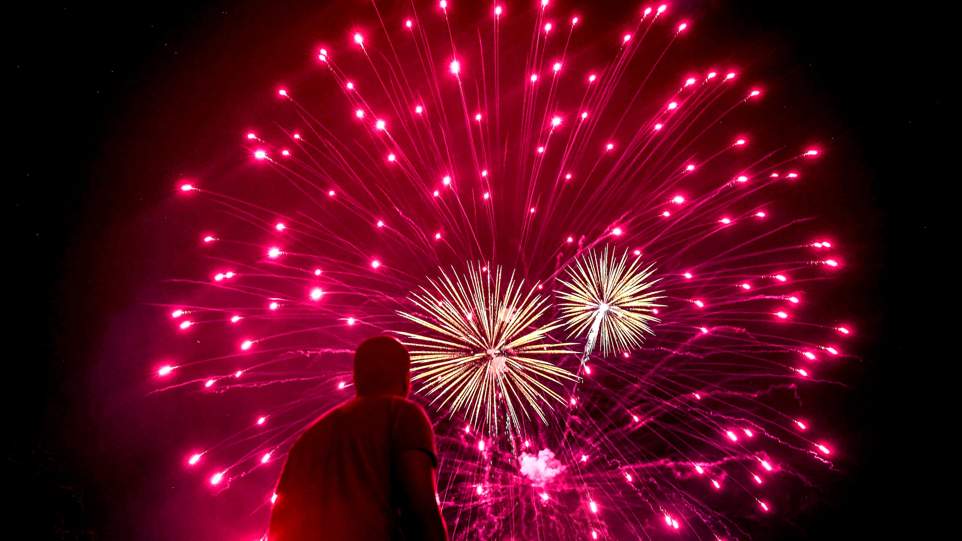 Spectators watch the fireworks show during Roswell’s Annual 4th of July Celebration at Roswell Area Park on Thursday, July 4, 2024. (Natrice Miller/ AJC)