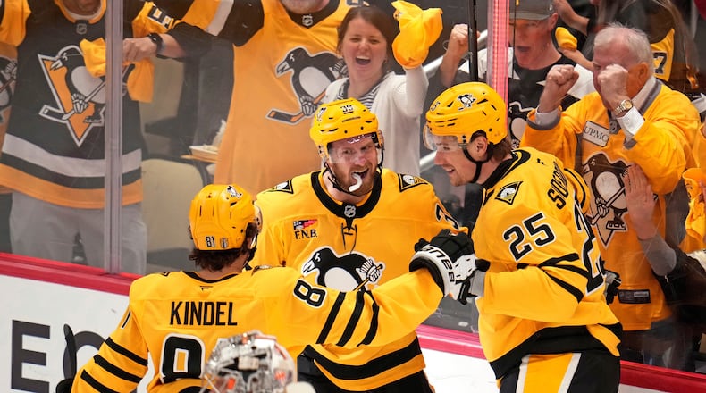 Pittsburgh Penguins' Elmer Soderblom (25) celebrates with Ben Kindel (81) and Anthony Mantha (39) after scoring against the Philadelphia Flyers during the first period of Game 5 in the first round of an NHL hockey Stanley Cup playoff series in Pittsburgh, Monday, April 27, 2026. (AP Photo/Gene J. Puskar)