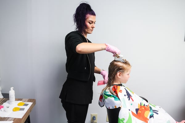 Technician Marina Birkhoff combs through a client's hair in the Lice Ladies studio in Atlanta on Wednesday, July 9, 2025. (Abbey Cutrer/AJC)