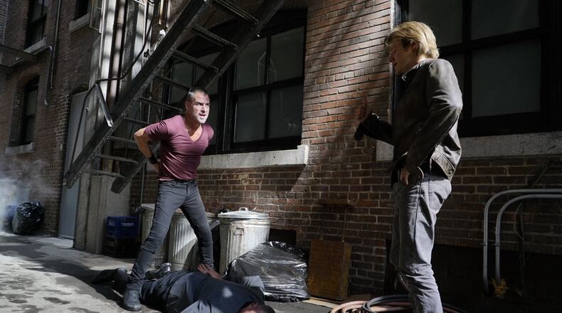 "The Rising" -- Shooting in the Fairlie-Poplar District of downtown Atlanta (but fictionally set in San Francisco in this episode) Angus "Mac" MacGyver (Lucas Till) and Jack Dalton (George Eads), special agents for the Department of External Services (DXS), join forces to recover a missing bioweapon that has the ability to destroy hundreds of thousands of people with one single drop, on the series premiere of the new drama MACGYVER, Friday, Sept. 23 (8:00-9:00 PM, ET/PT), on the CBS Television Network. Lucas Till, George Eads, Sandrine Holt, Justin Hires and Tristin Mays star. Pictured: George Eads, Vinnie Jones, Lucas Till Photo: Annette Brown/CBS é2016 CBS Broadcasting, Inc. All Rights Reserved