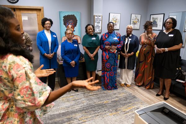 Mariama Keita-Thiero, far left, gives some last minute instructions before an event to celebrate Black women mayors from local cities in College Park on Wednesday, Feb. 28, 2024. Shown from left are Bianca Motley Broom from College Park, Rochelle Robinson from Douglasville, Beverly Burks from Clarkston, Angelyne Butler from Forest Park, Marci Fluellyn from Lovejoy, Teresa Thomas Smith from Palmetto and Sandra Vincent from McDonough.  (Ben Gray / Ben@BenGray.com)