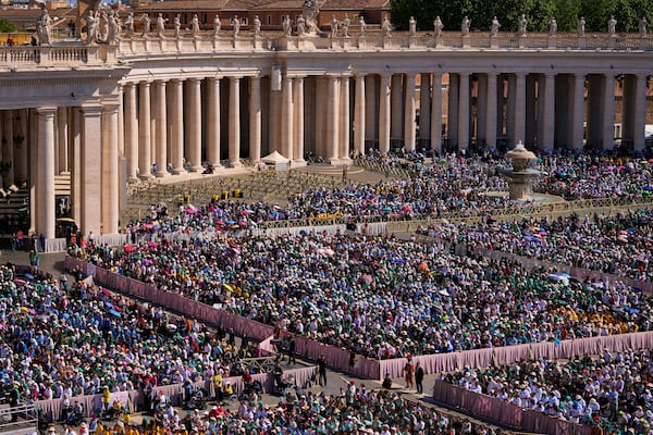 People attend a mass presided over by Vatican Secretary of State, Cardinal Pietro Parolin on the second of nine days of mourning for late Pope Francis in St. Peter's Square, at the Vatican, Sunday, April 27, 2025. (AP Photo/Andreea Alexandru)