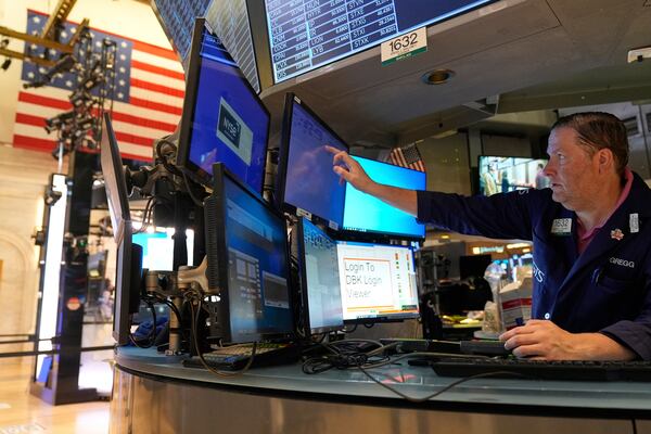 Gregg Maloney works on the floor at the New York Stock Exchange in New York, Wednesday, July 16, 2025. (AP Photo/Seth Wenig)