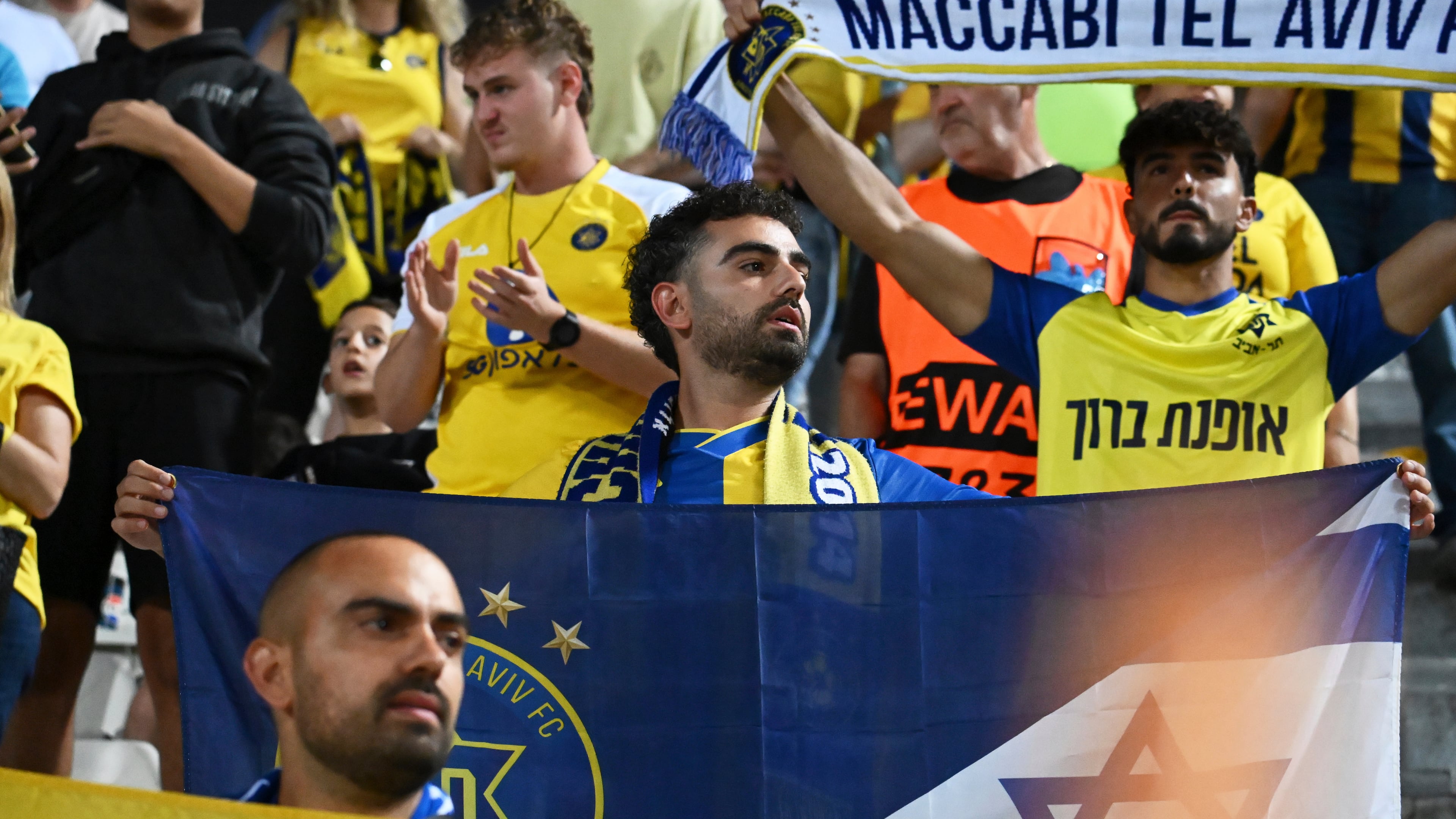 Maccabi Tel Aviv's fans clap hands after the end of the Europa League soccer match between PAOK and Maccabi Tel Aviv at Toumpa stadium, in Thessaloniki, Greece, Wednesday, Sept. 24, 2025. (AP Photo/Giannis Papanikos)