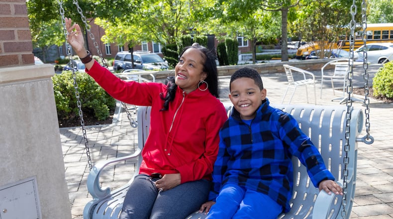 Immanuel Stephens swings with his mother Lisa at the Sandy Springs City Green Park. Immanuel , 7, participated in the Autism Transit Project for MARTA.  PHIL SKINNER FOR THE ATLANTA JOURNAL-CONSTITUTION