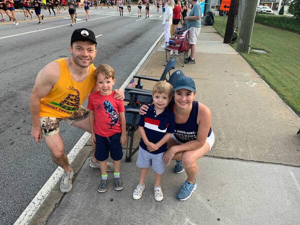 Shown on Sunday, July 4, 2021, Elizabeth and Dustin White have been cheering on racers at the same location for the past six years. (Photo: Isaiah Poritz/AJC)