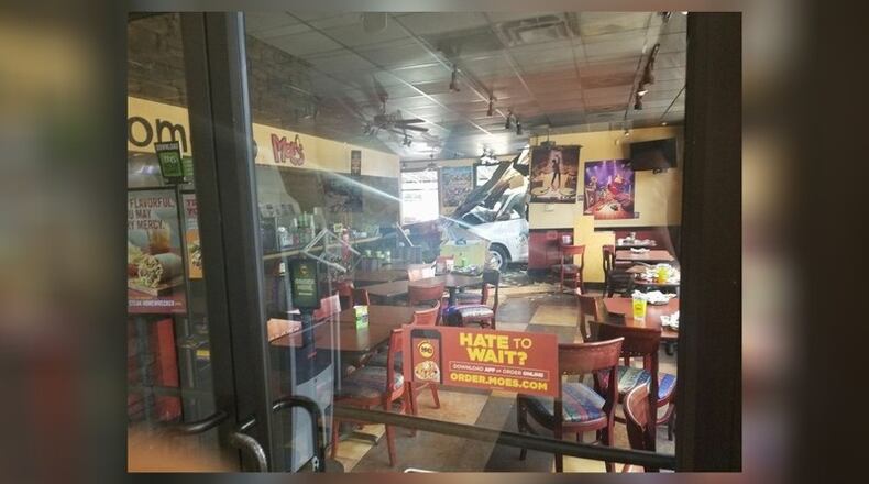 A nine-vehicle wreck ended with a van crashing through a Moe's restaurant in North Georgia. (Credit: Channel 2 Action News)