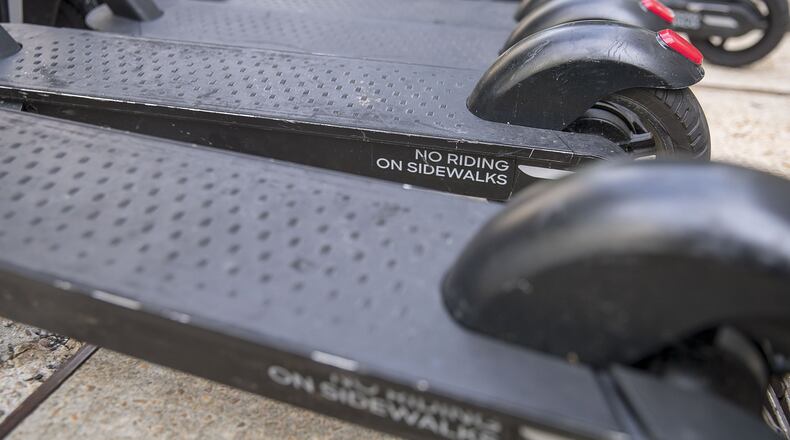 The message to not ride an e-scooter on the sidewalk is displayed on the base of a scooter parked along Peachtree Street NE in Atlanta’s Midtown, August 6, 2019. Alyssa Pointer/alyssa.pointer@ajc.com