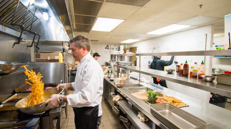 Chef Dieter Quinn prepares french fries in the Sigma Chi kitchen. CONTRIBUTED BY HENRI HOLLIS