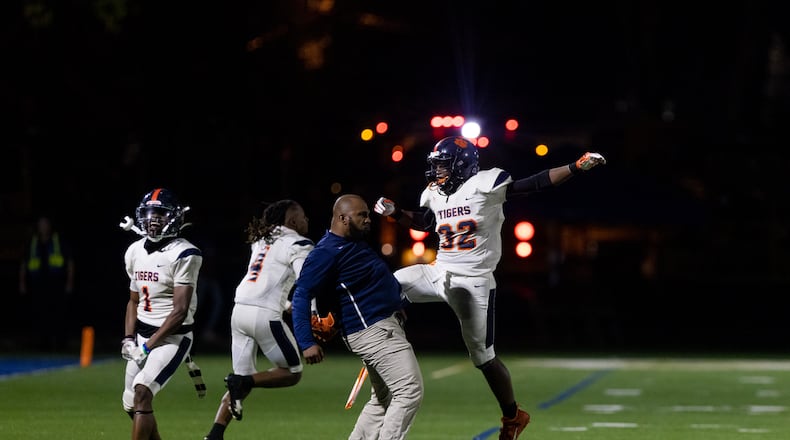 Mundy Mill’s Chris Joseph (32) celebrates with his coach during a GHSA High School football game between St. Pius and Mundy’s Mill at St. Pius Catholic School in Atlanta, GA, on Friday, November 11, 2022.(Photo/Jenn Finch)