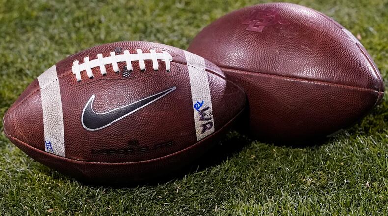FILE - Footballs rest on the field in the second half of an NCAA college football game Nov. 28, 2020, in Boulder, Colo. (AP Photo/David Zalubowski, File)