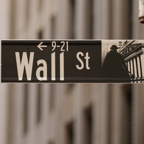 FILE - A Wall Street sign is seen outside of the New York Stock Exchange in New York, Monday, March 30, 2026. (AP Photo/Seth Wenig, File)