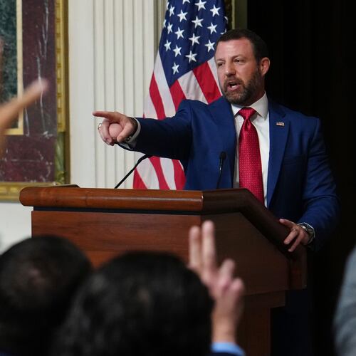 Reporters raise their hands as Homeland Security Secretary Markwayne Mullin speaks in the Indian Treaty Room at the Eisenhower Executive Office Building on the White House campus, Friday, July 17, 2026, in Washington. (AP Photo/Julia Demaree Nikhinson)