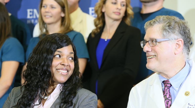 A smiling Amber Vinson sits at the table with Dr. Bruce Ribner, who directed her treatment for Ebola virus disease, after Vinson's discharge from Emory University Hospital on Tuesday. BOB ANDRES / BANDRES@AJC.COM