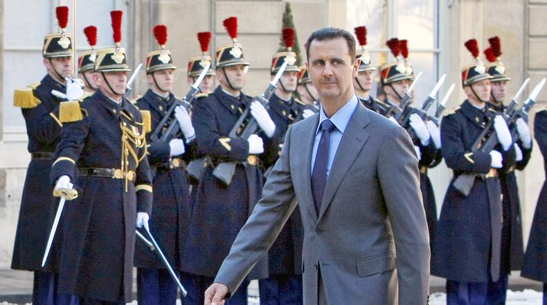FILE - In this Dec. 9, 2010 file photo, Syria President Bashar al-Assad arrives at the Elysee Palace in Paris for his meeting with French President Nicolas Sarkozy. (AP Photo/Remy de la Mauviniere, File)