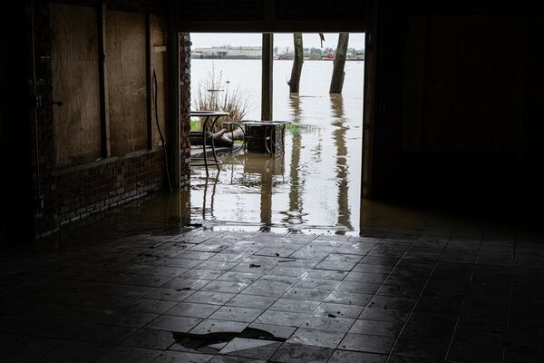 Floodwaters enter a garage in a home on the banks of the Ohio River on Saturday, April 5, 2025, in Louisville, Ky. (AP Photo/Jon Cherry)