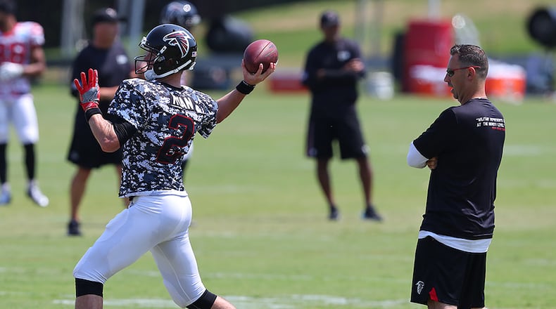 Falcons offensive coordinator Steve Sarkisian looks on as Matt Ryan throws a pass during team practice Sunday, August 6, 2017, in Flowery Branch. (Curtis Compton/ccompton@ajc.com)
