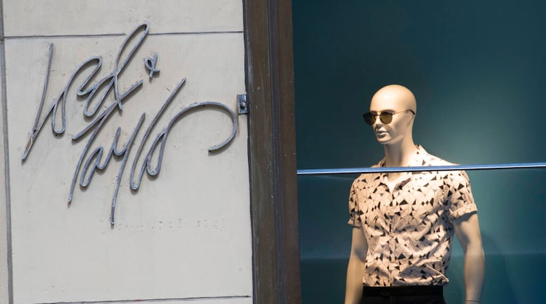 FILE - In this June 6, 2018, file photo the Lord & Taylor logo is seen next to a mannequin in a window display at their flagship store on Fifth Avenue in New York. Lord & Taylor, one of the nation’s oldest department stores, is closing. (AP Photo/Mary Altaffer, File)
