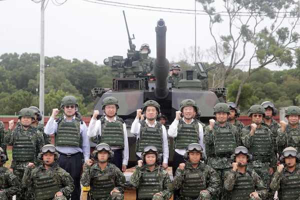 Taiwan President Lai Ching-te, center left in second row, poses with soldiers during a live-fire shooting training in Hsinchu County, Taiwan, Thursday, July 10, 2025. (AP Photo/Chiang Ying-ying)