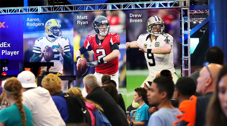 Thousands of football fans arriving in Houston for the Super Bowl take in the pro football interactive theme park the NFL Experience on Thursday. Curtis Compton, compton@ajc.com