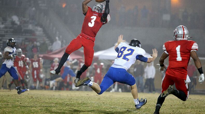 December 5, 2014 - Lawrenceville, Ga: Archer defensive back Dylan Singleton (3) makes an interception over Etowah tight end Patrick Oliver (82) in the first half of their game against Etowah in the Class AAAAAA semifinal Friday night at Archer High School in Lawrenceville, Ga., December 5, 2014. Singleton returned the interception for a touchdown. PHOTO / JASON GETZ