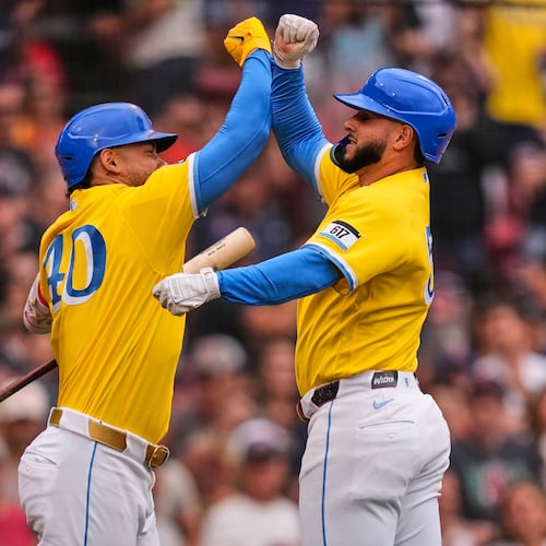 Boston Red Sox's Wilyer Abreu, right, is congratulated by Willson Contreras after hitting a solo home run in the third inning of a baseball game against the Tampa Bay Rays, Saturday, July 18, 2026, in Boston. (AP Photo/Charles Krupa)