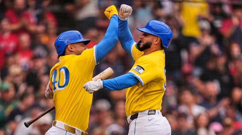 Boston Red Sox's Wilyer Abreu, right, is congratulated by Willson Contreras after hitting a solo home run in the third inning of a baseball game against the Tampa Bay Rays, Saturday, July 18, 2026, in Boston. (AP Photo/Charles Krupa)